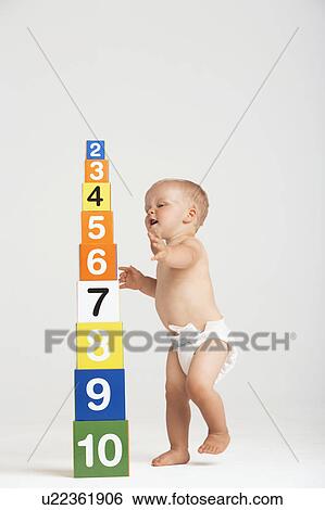 Baby Approaching Tower of Number Blocks View Large Photo Image Stock Photograph - Baby Approaching Tower of Number Blocks. Fotosearch