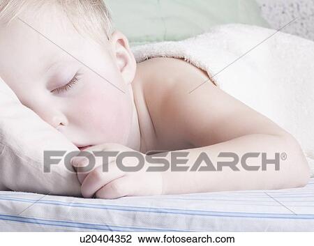 Baby boy lies sleeping View Large Photo Image Stock Image - Baby boy lies sleeping. Fotosearch