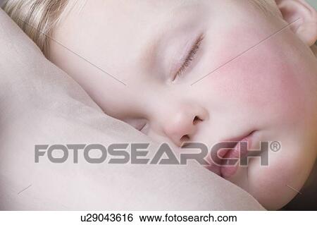 Baby boy lies sleeping View Large Photo Image Stock Photograph - Baby boy lies sleeping. Fotosearch