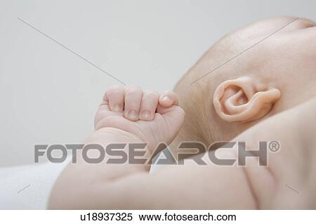 Stock Photography - Baby boy lying down, close-up. Fotosearch
