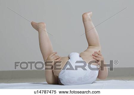 Baby girl playing on floor, upside-down View Large Photo Image Stock Photography - Baby girl playing on floor, upside-down. Fotosearch