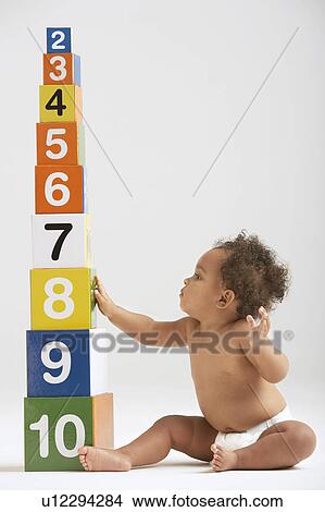 Picture - Baby Sitting by Tower of Number Blocks. Fotosearch
