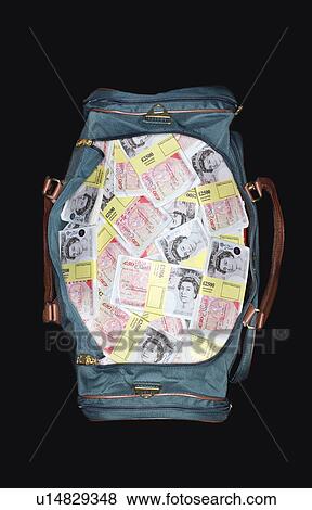 Stock Photo - Bag full of sealed Pound banknotes, view from above. Fotosearch