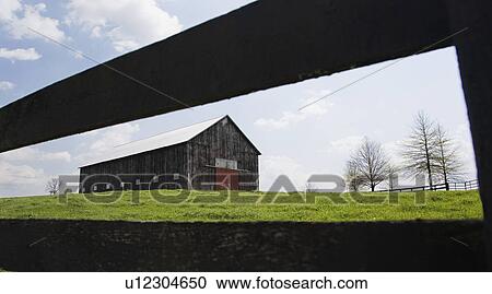 Barn in field with fence View Large Photo Image Stock Image - Barn in field with fence. Fotosearch