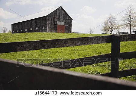 Stock Photo - Barn in field with fence. Fotosearch