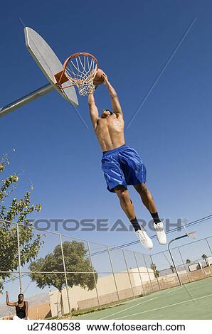 Basketball player, mid-air, dunking ball View Large Photo Image Stock Photo - Basketball player, mid-air, dunking ball. Fotosearch