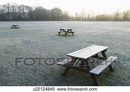 Stock Photo - Benches on empty field. Fotosearch