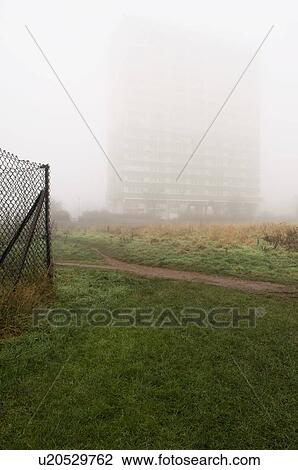 Stock Image - Block of flats hidden behind fog. Fotosearch