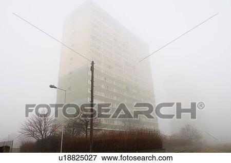 Stock Photo - Block of flats hidden behind fog. Fotosearch