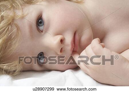 Boy (1-2 years) lying down View Large Photo Image Stock Photo - Boy (1-2 years) lying down. Fotosearch