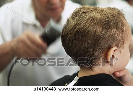 Stock Photo - Boy (3-4) having head shaved by barber. Fotosearch