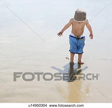Boy (3-4) on beach View Large Photo Image Picture - Boy (3-4) on beach. Fotosearch