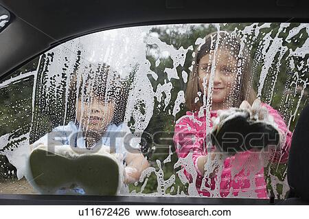 Boy and girl (7-9) washing car together, view from inside car View Large Photo Image Stock Photograph - Boy and girl (7-9) washing car together, view from inside car. Fotosearch