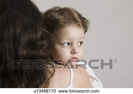 Boy embracing mother, close-up View Large Photo Image Stock Image - Boy embracing mother, close-up. Fotosearch