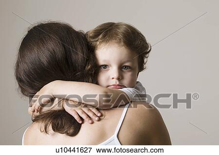 Stock Photo - Boy embracing mother, close-up. Fotosearch