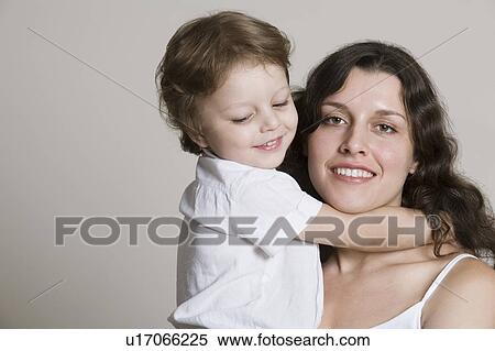 Boy embracing mother, close-up View Large Photo Image Stock Photography - Boy embracing mother, close-up. Fotosearch