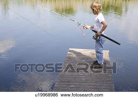 Boy fishing from jetty View Large Photo Image Stock Photograph - Boy fishing from jetty. Fotosearch