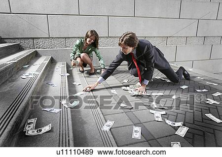 Busines man and woman collecting money on steps View Large Photo Image Stock Photo - Busines man and woman collecting money on steps. Fotosearch