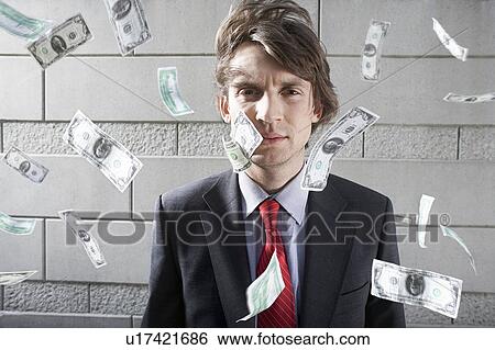 Busines man surrounded by falling money, outdoors, portrait View Large Photo Image Stock Photograph - Busines man surrounded by falling money, outdoors, portrait. Fotosearch