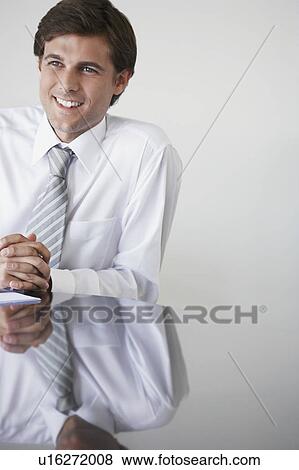 Business man sitting at conference table View Large Photo Image Stock Photo - Business man sitting at conference table. Fotosearch