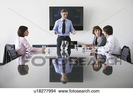 Picture - Business man talking to colleagues in conference meeting. Fotosearch