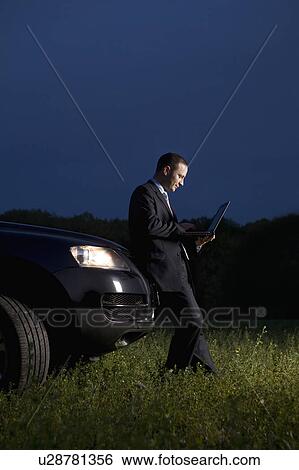 Business man using laptop in field View Large Photo Image Stock Photograph - Business man using laptop in field. Fotosearch