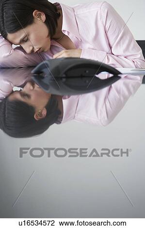 Business woman sleeping beside telephone at conference table View Large Photo Image Stock Image - Business woman sleeping beside telephone at conference table. Fotosearch