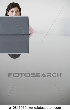 Stock Photo - Business woman using laptop at conference table. Fotosearch