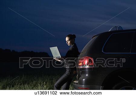 Business woman using laptop in field View Large Photo Image Stock Image - Business woman using laptop in field. Fotosearch