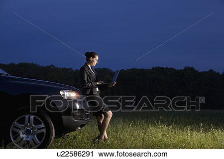 Business woman using laptop in field View Large Photo Image Stock Image - Business woman using laptop in field. Fotosearch