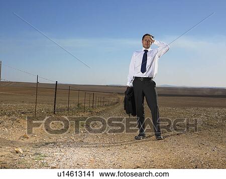 Businessman holding his head in the middle of nowhere View Large Photo Image Stock Image - Businessman holding his head in the middle of nowhere. Fotosearch