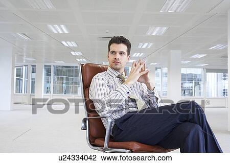 Stock Image - Businessman in Empty Office Space. Fotosearch