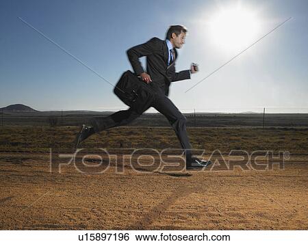 Businessman Running Down Deserted Road View Large Photo Image Stock Photograph - Businessman Running Down Deserted Road. Fotosearch