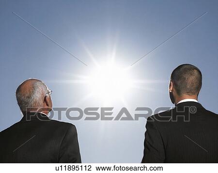 Businessmen looking at the sun, head and shoulders, back view View Large Photo Image Stock Image - Businessmen looking at the sun, head and shoulders, back view. Fotosearch