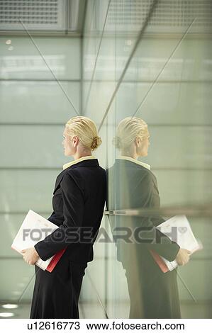 Businesswoman and Reflection in Office Corridor View Large Photo Image Stock Image - Businesswoman and Reflection in Office Corridor. Fotosearch