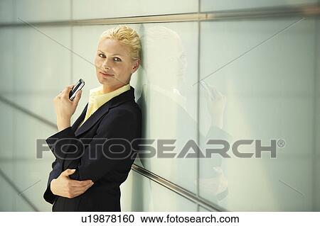 Stock Image - Businesswoman Using Cell Phone, portrait. Fotosearch