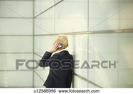 Businesswoman Using Cell Phone, side view View Large Photo Image Stock Photograph - Businesswoman Using Cell Phone, side view. Fotosearch