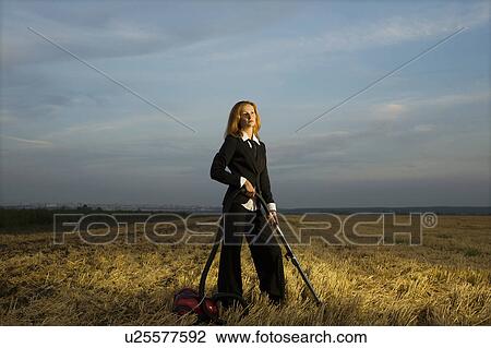 Businesswoman Vacuuming a Field View Large Photo Image Stock Image - Businesswoman Vacuuming a Field. Fotosearch