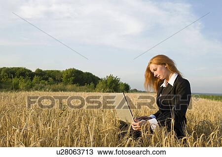 Businesswoman with a Laptop in a Field View Large Photo Image Stock Image - Businesswoman with a Laptop in a Field. Fotosearch