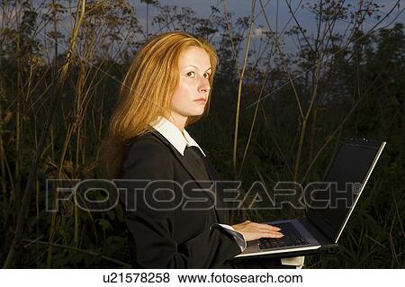 Stock Photo - Businesswoman with a Laptop in a Woodland. Fotosearch