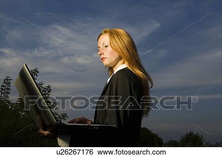 Stock Photograph - Businesswoman with a Laptop Outdoors. Fotosearch