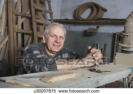 Stock Photography - Carpenter in Workshop. Fotosearch