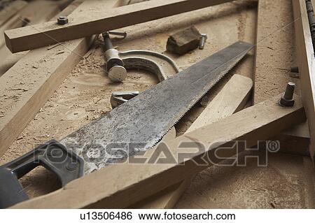 Stock Photograph - Carpenter's Saw and Clamp Among Wood Shavings. Fotosearch