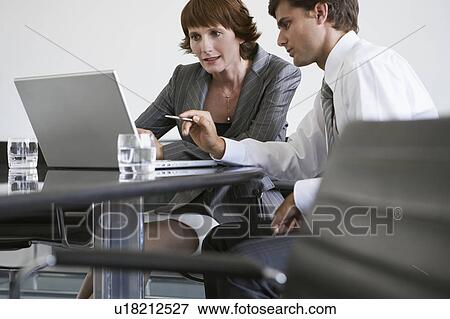 Stock Photo - Casual business meeting of two people in conference room. Fotosearch