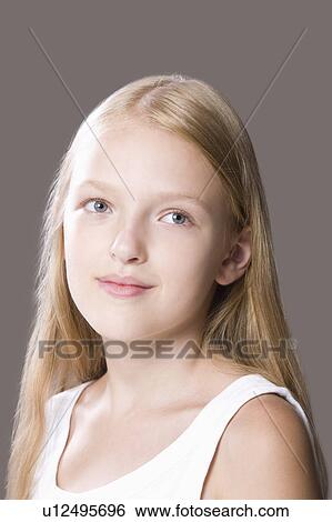 Stock Photograph - Close-up of teenage girl (13-15), studio shot. Fotosearch