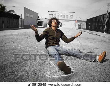 Confused young man sitting in street View Large Photo Image Stock Photography - Confused young man sitting in street. Fotosearch