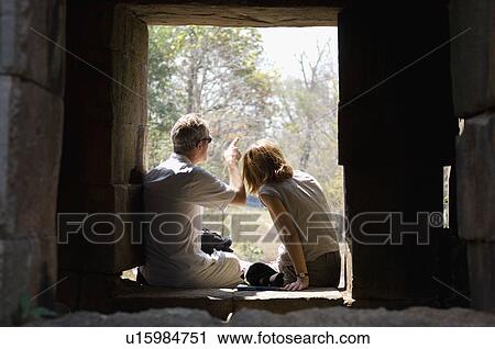 Couple Sitting in Window of Stone Building View Large Photo Image Stock Image - Couple Sitting in Window of Stone Building. Fotosearch