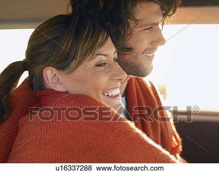 Couple wrapped in blanket in front seat of van, profile, head and shoulders View Large Photo Image Stock Photo - Couple wrapped in blanket in front seat of van, profile, head and shoulders. Fotosearch
