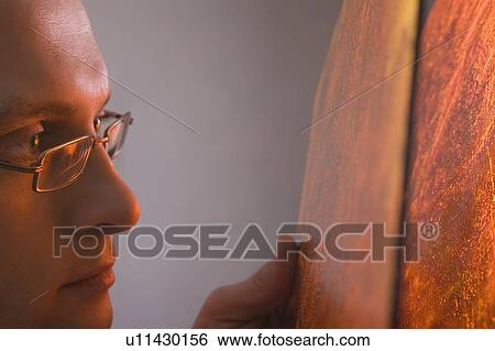Stock Photograph - Craftsman examines surface. Fotosearch
