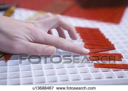 Craftswoman pushes red glass into position View Large Photo Image Stock Photo - Craftswoman pushes red glass into position. Fotosearch